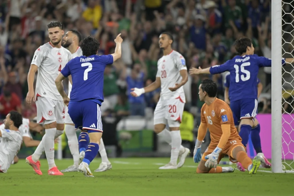 Japan hit four to reach brink of knockout stage as Tunisia exit